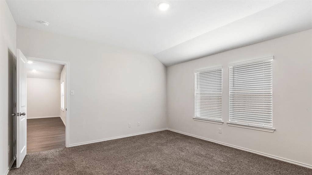 3037 Hidden Valley Drive, Lindale, TX 75771 Vaulted ceiling room with recessed lighting, two windows with blinds, and carpet flooring