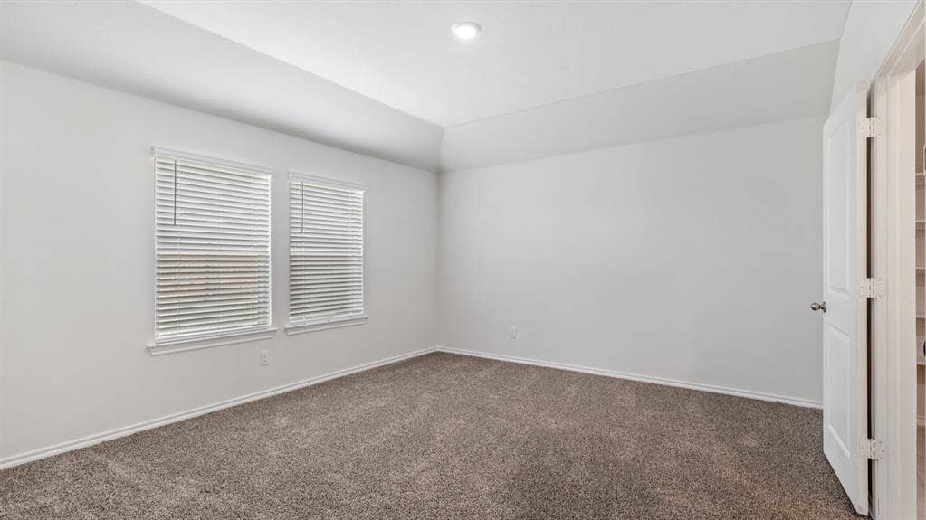 3037 Hidden Valley Drive, Lindale, TX 75771 Tray ceiling with recessed lighting, two windows with blinds, plush gray carpeting, and a white paneled door