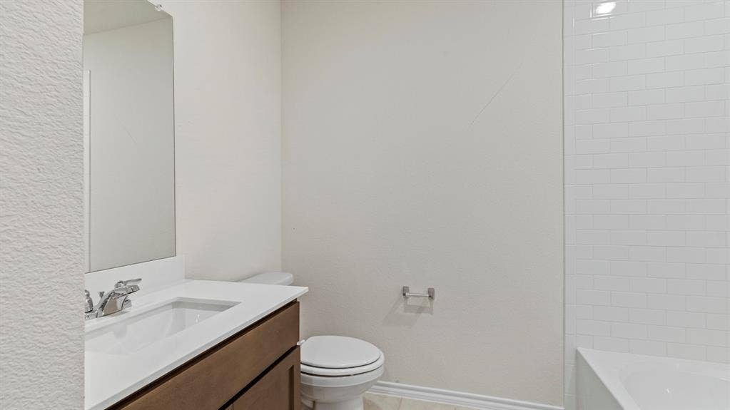 3037 Hidden Valley Drive, Lindale, TX 75771 Vanity with an integrated sink, polished chrome faucet, and a wall-mounted mirror