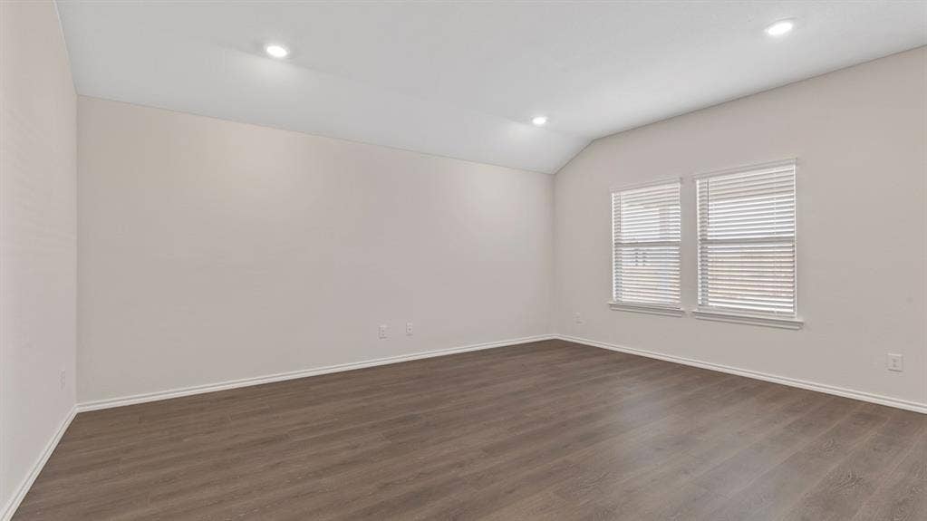3037 Hidden Valley Drive, Lindale, TX 75771 Vaulted ceiling with recessed lighting, wood-finish flooring, and dual windows with blinds