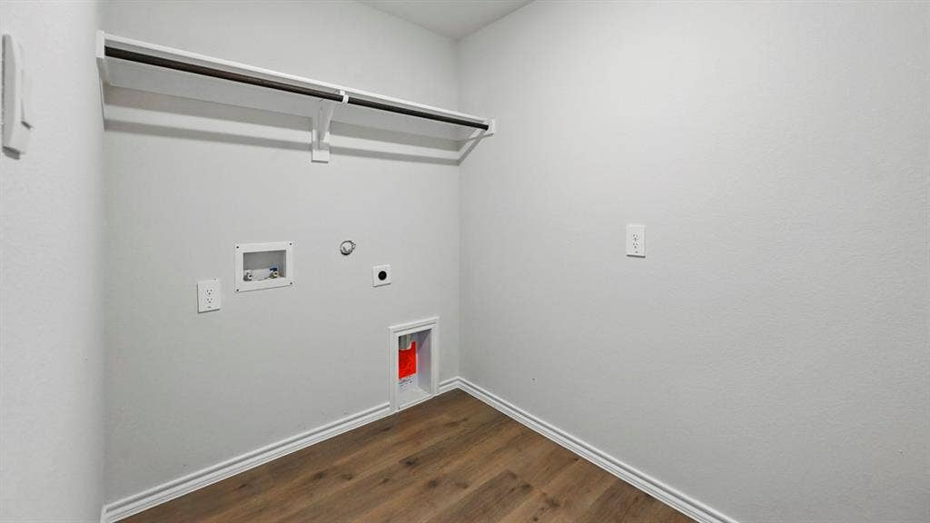 181 Brooks Street, Bullard, TX 75757 Laundry area featuring wood-finish flooring, a clothing rod, and essential appliance hookups