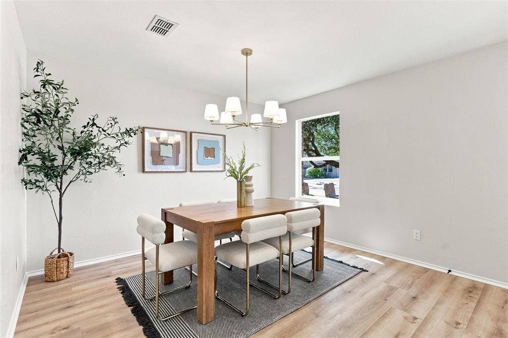 1406 Quail Meadow Drive, Wylie, TX 75098 Recessed window, wood-finish flooring, gold-tone chandelier, and light-toned wall paint