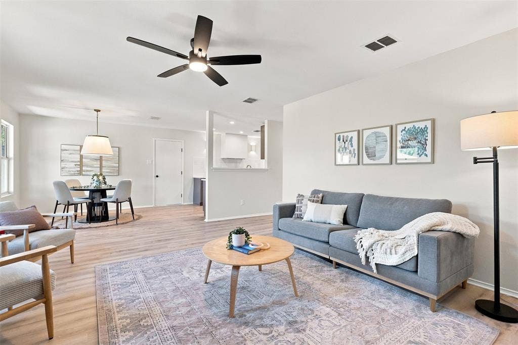 1406 Quail Meadow Drive, Wylie, TX 75098 Bright open-concept living area featuring wood-finish flooring, recessed lighting, and a modern ceiling fan