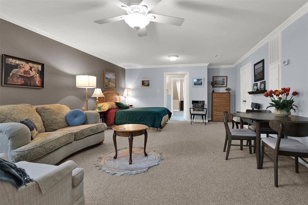 2720 Oates Drive, Mesquite, TX 75150 Open-concept room featuring carpeting, crown molding, a ceiling fan, and distinct wall colors