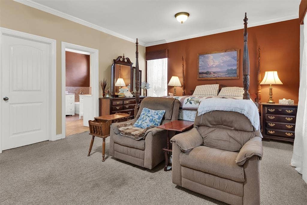 2720 Oates Drive, Mesquite, TX 75150 Warm-toned accent wall, carpeted flooring, and a white six-panel door with an arched top panel