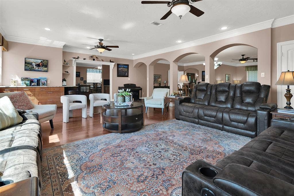2720 Oates Drive, Mesquite, TX 75150 Hardwood-finish flooring, recessed lighting, crown molding, arched doorways, and built-in cabinetry