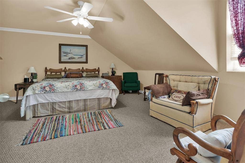 2720 Oates Drive, Mesquite, TX 75150 Carpeted room with sloped ceilings and a ceiling fan