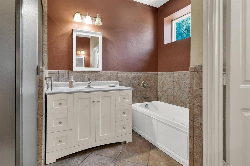 2720 Oates Drive, Mesquite, TX 75150 White vanity with stone countertop, integrated sink, and chrome fixtures