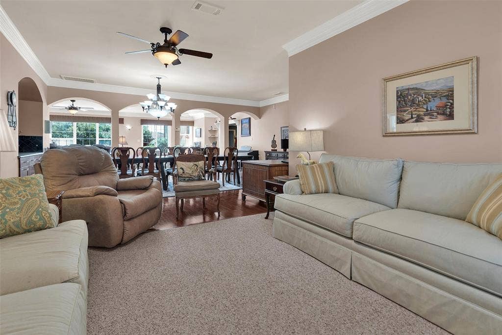 2720 Oates Drive, Mesquite, TX 75150 Recessed ceiling fan, crown molding, arched entryways, wood-finish flooring, and light carpeting
