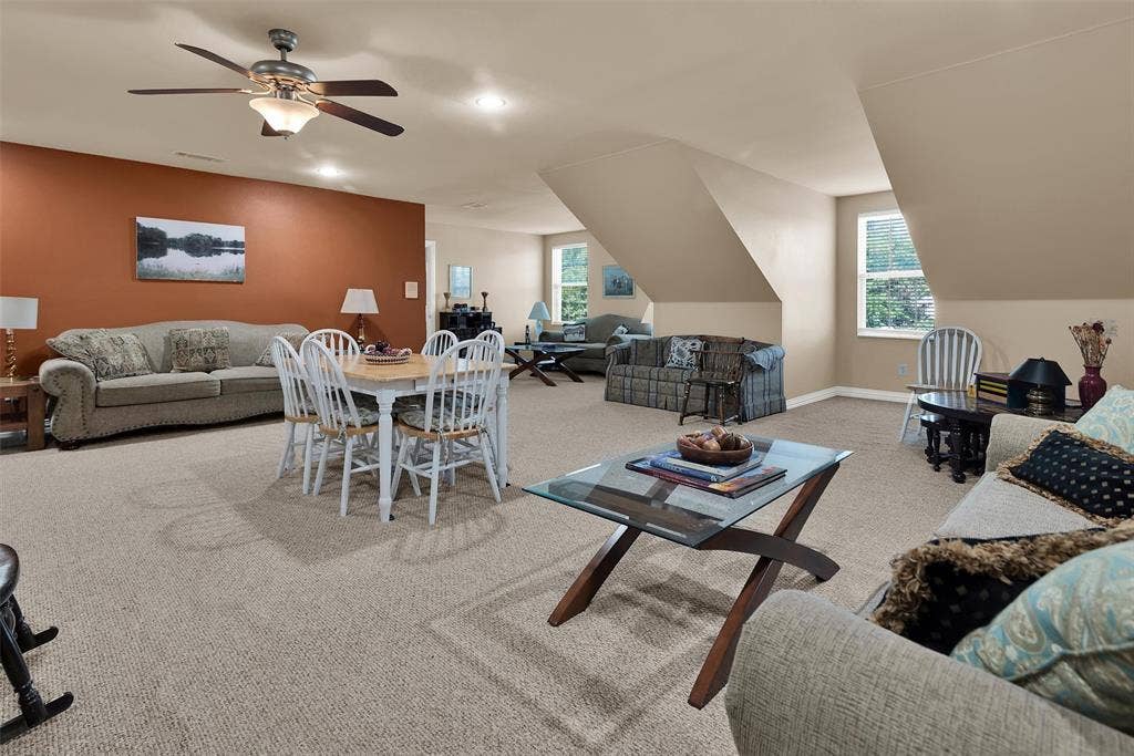 2720 Oates Drive, Mesquite, TX 75150 Expansive carpeted area with vaulted ceilings, recessed lighting, and multiple window openings