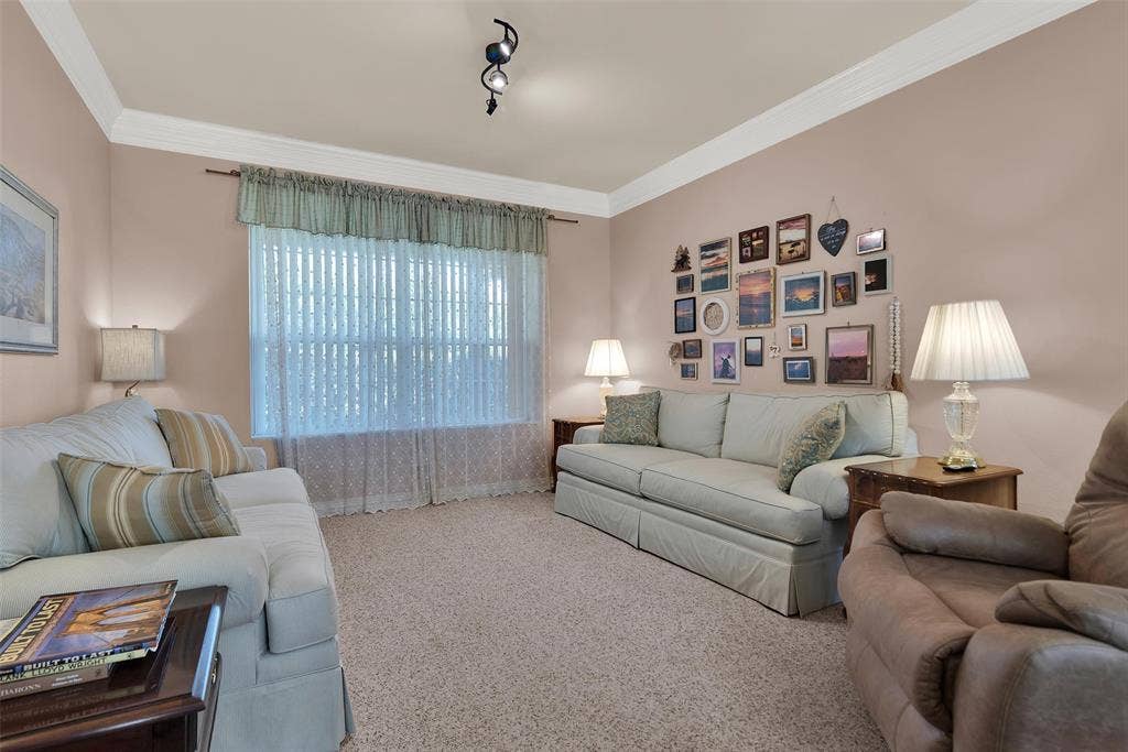 2720 Oates Drive, Mesquite, TX 75150 Recessed window with vertical blinds, textured wall finish, crown molding, and track lighting fixture