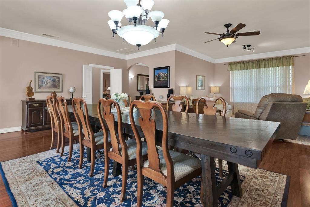 2720 Oates Drive, Mesquite, TX 75150 Formal dining area with wood-finish flooring, crown molding, and a chandelier