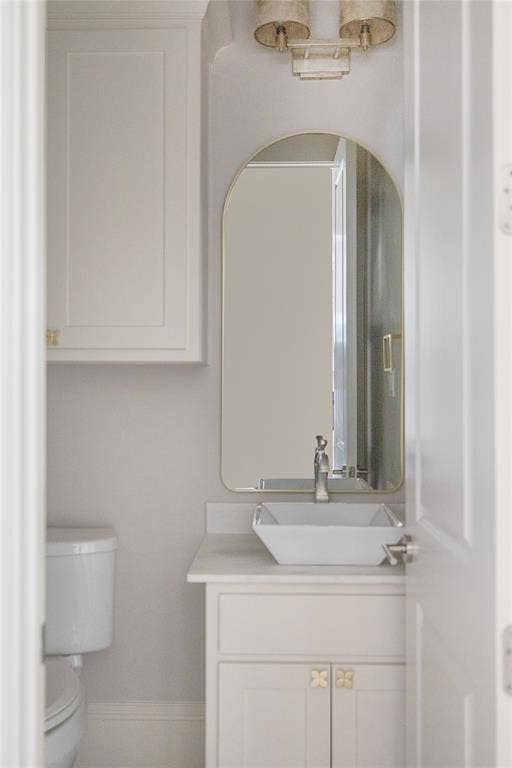 White shaker-style vanity with a vessel sink and single-handle faucet