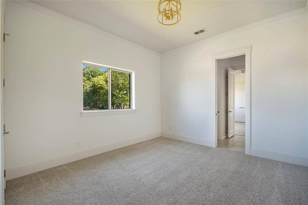 Recessed window, crown molding, cased doorway, recessed lighting, and a decorative ceiling fixture