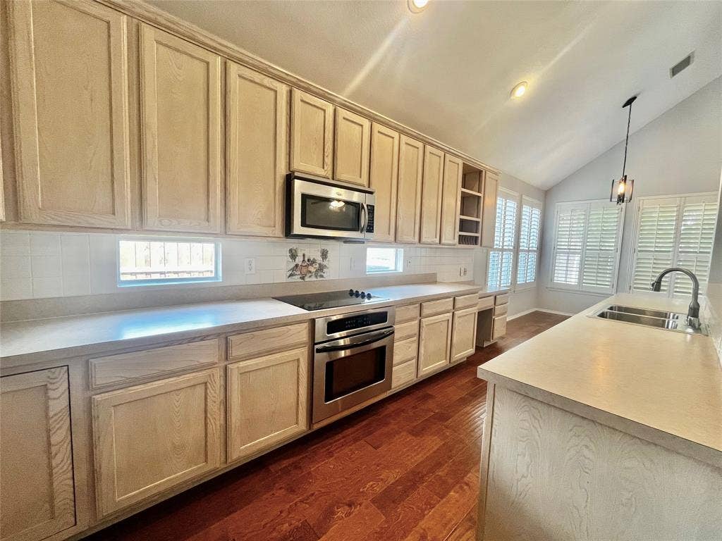 4100 Burnhill Drive, Plano, TX 75024 stainless appliances, sink, faucet, microwave, oven is also a convection oven. Love these transom windows for extra light!