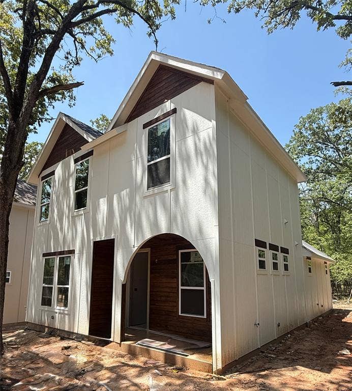 130 Carolyn Road, Mabank, TX 75156 Contemporary exterior with white siding and dark wood accents