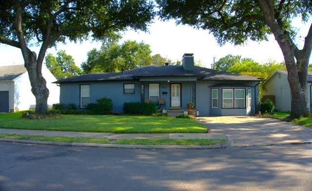 5012 Wateka Drive, Dallas, TX 75209 Single-story residence with a gray exterior finish, a black shingle roof, and a prominent bay window