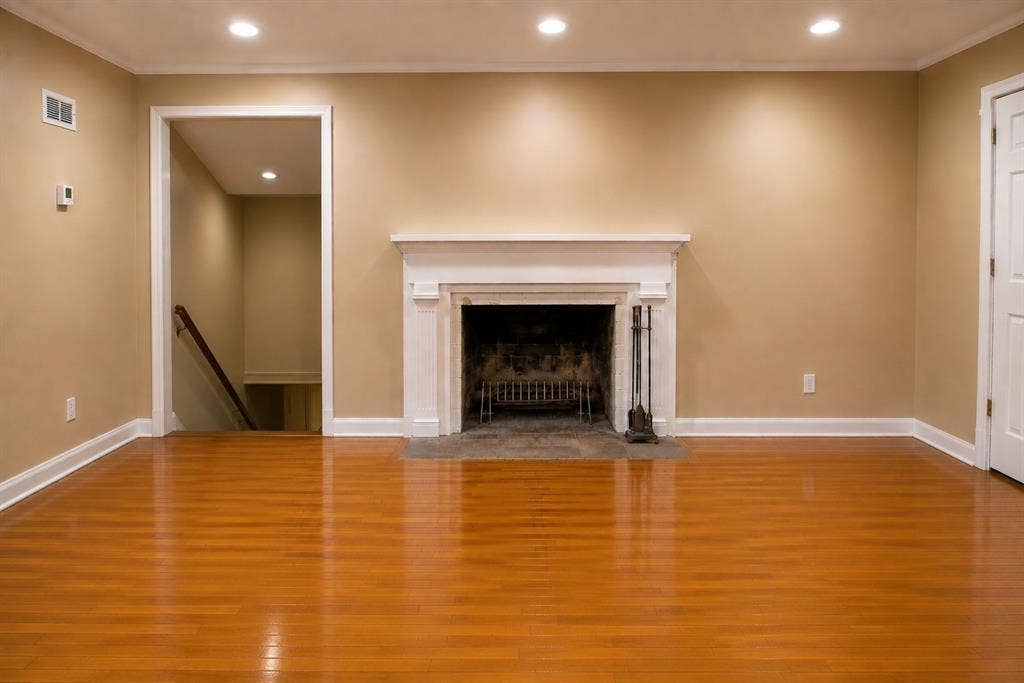 5012 Wateka Drive, Dallas, TX 75209 Hardwood flooring, recessed lighting, white trim and baseboards, and a fireplace with a white mantel and hearth