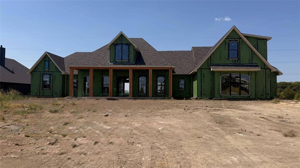 2412 Independence Drive, Anna, TX 75409 New construction home featuring a covered front porch with wood columns, an arched window, and a gabled roofline
