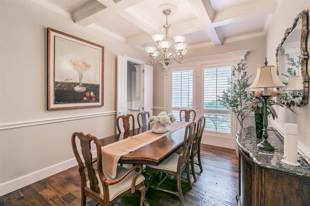 313 Elkhorn Trail, Keller, TX 76248 Tray ceiling with crown molding and a chandelier, hardwood flooring, dual windows with plantation shutters,