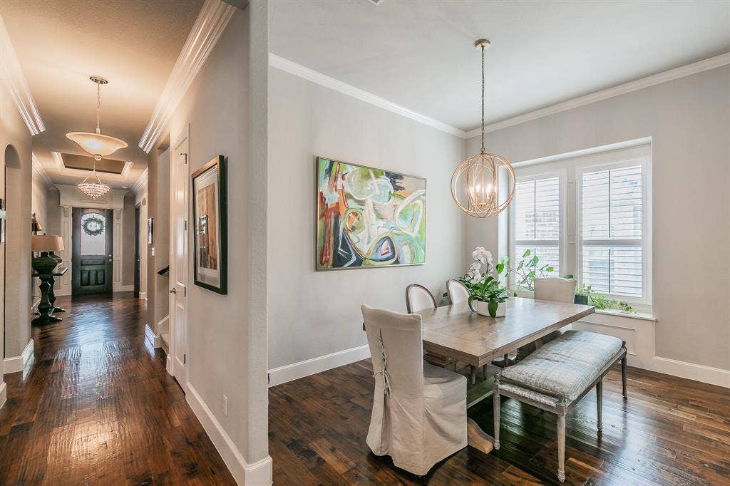 313 Elkhorn Trail, Keller, TX 76248 Hardwood flooring, crown molding, white window shutters, and a decorative chandelier