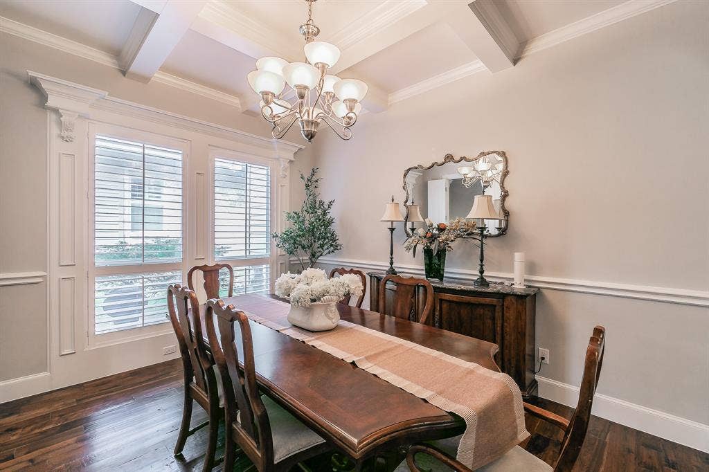 313 Elkhorn Trail, Keller, TX 76248 Coffered ceiling featuring a chandelier, wood flooring, white plantation shutters, decorative wall molding, and crown molding