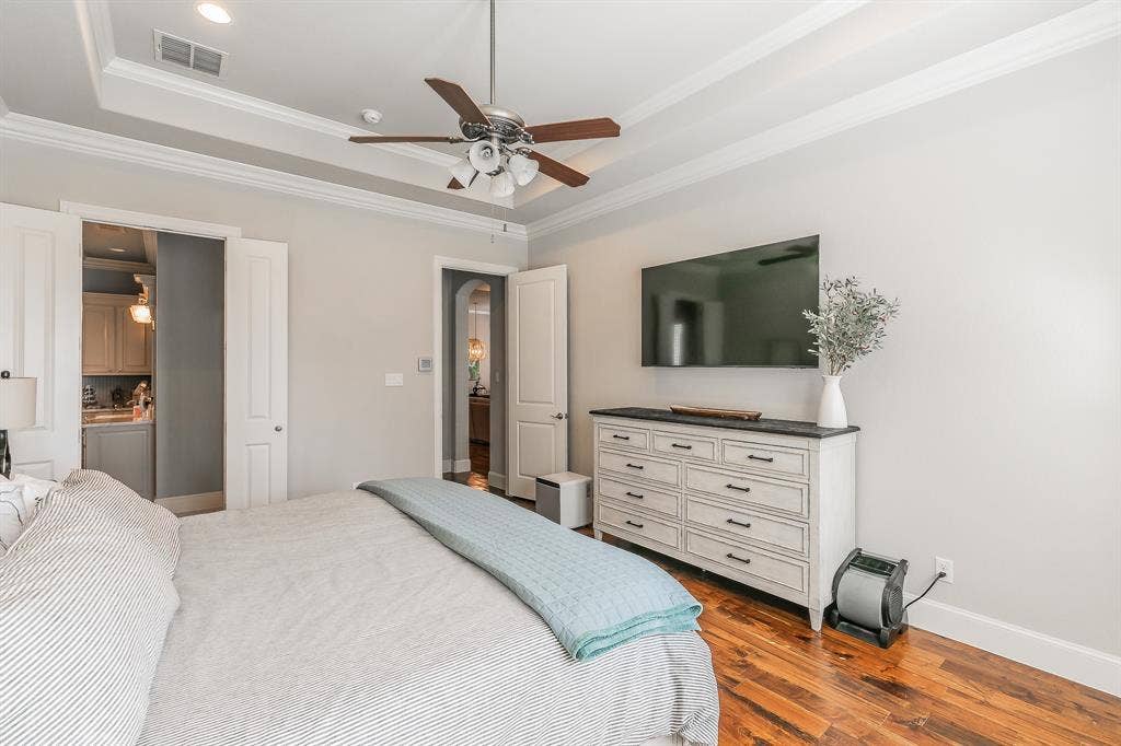 313 Elkhorn Trail, Keller, TX 76248 Tray ceiling with crown molding, ceiling fan with integrated lighting, white paneled doors