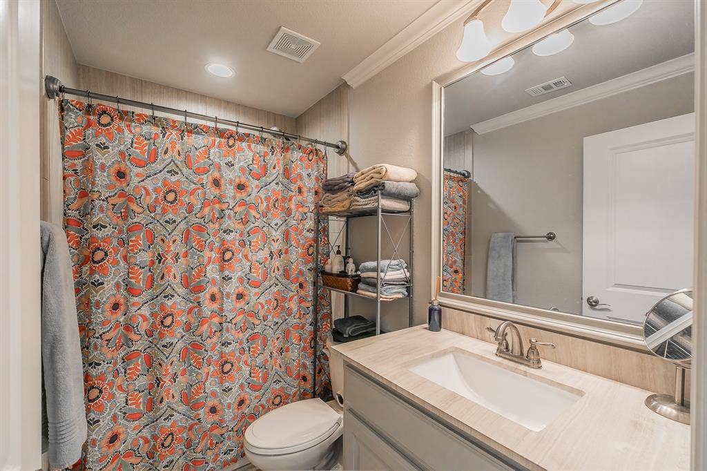 313 Elkhorn Trail, Keller, TX 76248 Vanity with integral sink, brushed nickel faucet, and a large framed mirror
