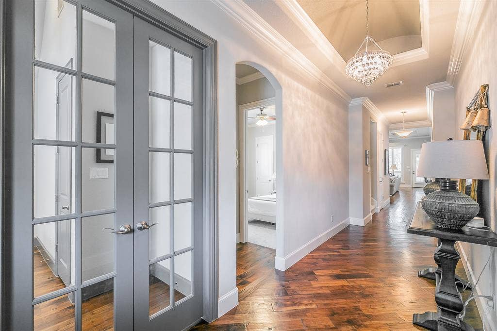 313 Elkhorn Trail, Keller, TX 76248 Tray ceiling with a crystal chandelier, wood flooring, and crown molding