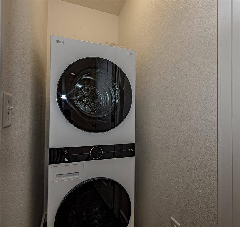 3022 Forest Lane, #116, Dallas, TX 75234 Utility closet featuring stacked washer / dryer - New LG with outstanding features