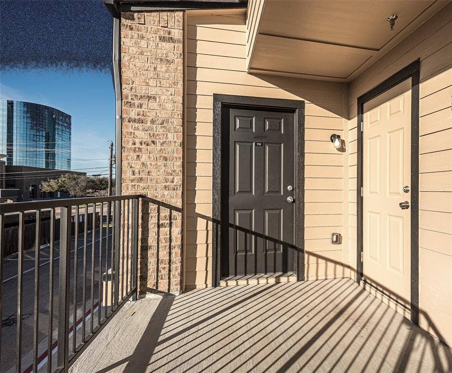 3022 Forest Lane, #116, Dallas, TX 75234 View of exterior entry featuring a balcony