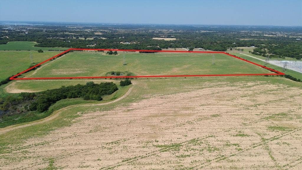1566 Fm 2194, Farmersville, TX 75442 Expansive agricultural land featuring a demarcated perimeter, lush green fields, and surrounding tree lines