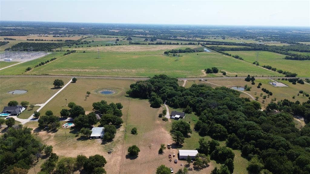 1566 Fm 2194, Farmersville, TX 75442 Expansive acreage featuring multiple fields, wooded areas, and a visible pond