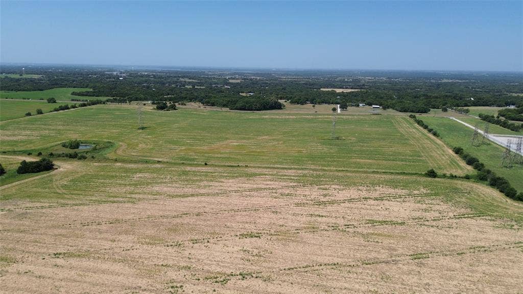 1566 Fm 2194, Farmersville, TX 75442 Expansive land featuring open fields, distant treelines, and clear skies