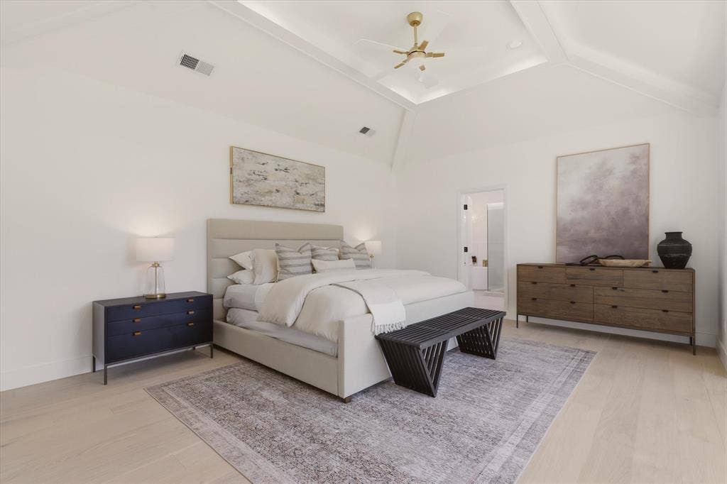 Vaulted ceiling with recessed lighting and a ceiling fan, light wood-finish flooring, and white walls