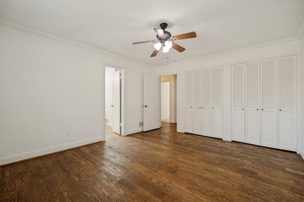 5818 E University Boulevard, #138, Dallas, TX 75206 Wood-finish flooring, crown molding, ceiling fan with integrated lighting, and louvered bifold closet doors