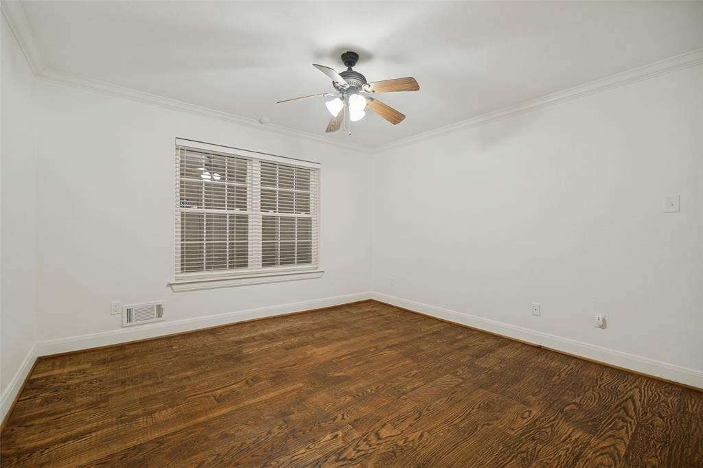 5818 E University Boulevard, #138, Dallas, TX 75206 Hardwood flooring, crown molding, double-pane window with blinds, and a ceiling fan with integrated lighting