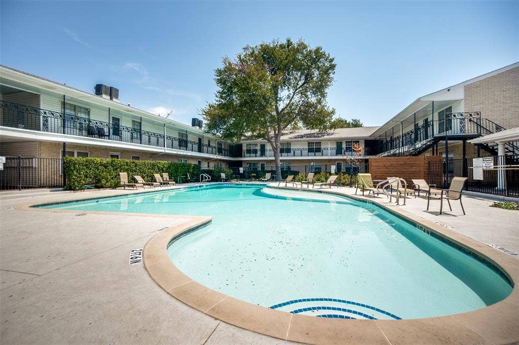 5818 E University Boulevard, #138, Dallas, TX 75206 Irregularly shaped swimming pool with a tile-lined entry, surrounded by a concrete deck