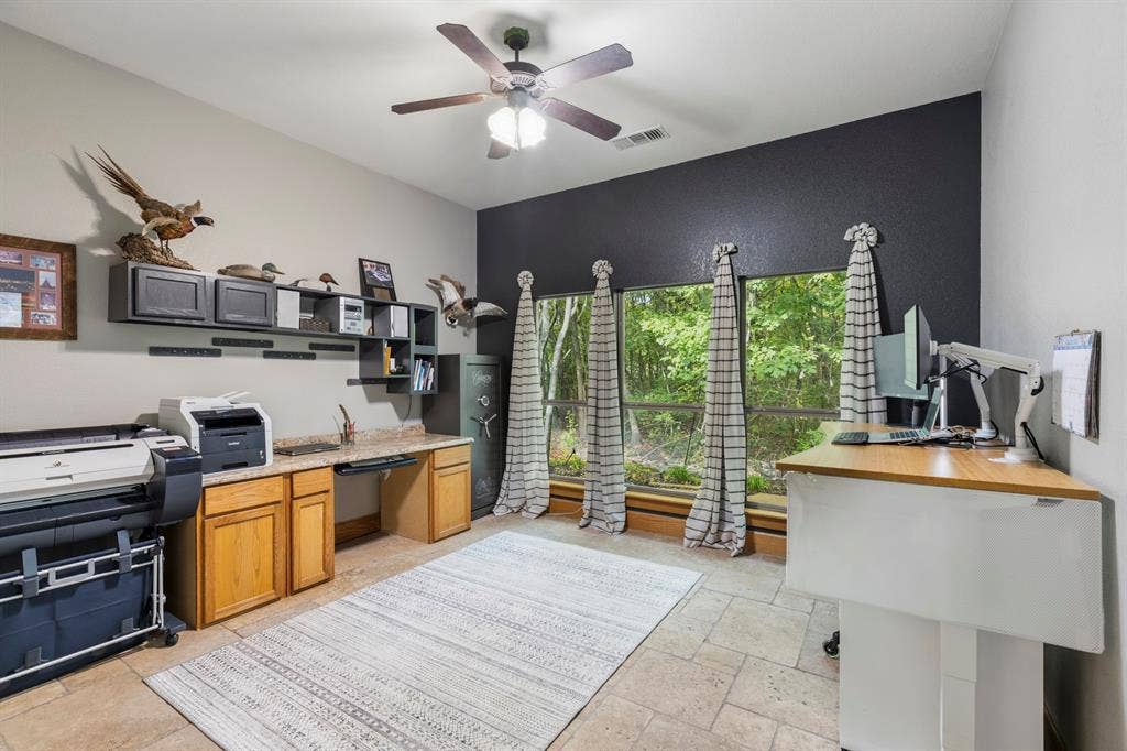 6810 Trinity Falls Parkway, McKinney, TX 75071 Vaulted ceiling with a ceiling fan, built-in cabinetry with a countertop, window wall, and tile flooring