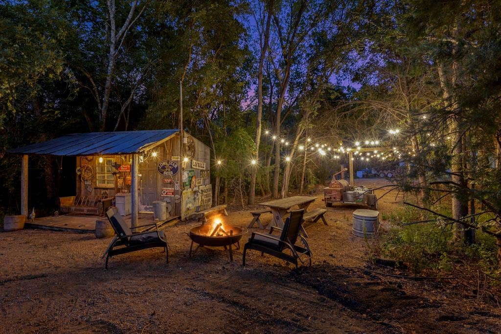 6810 Trinity Falls Parkway, McKinney, TX 75071 Wood-sided shed with a metal roof, outdoor string lighting, and a metal fire pit