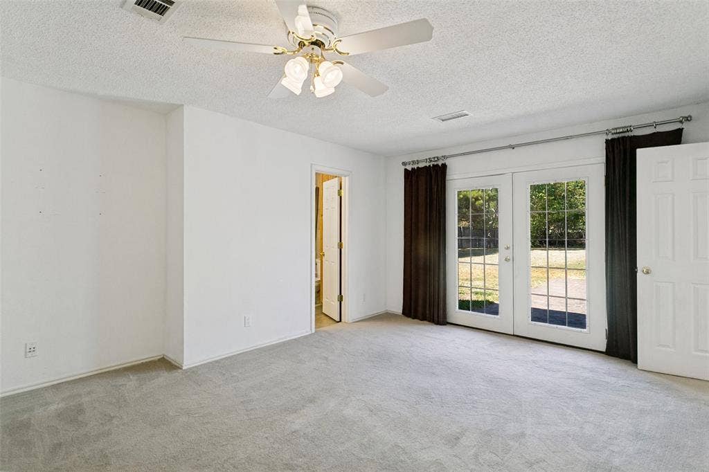 2717 Pinehurst Drive, Plano, TX 75075 Wall-to-wall carpeting, white walls, and a ceiling fan with light