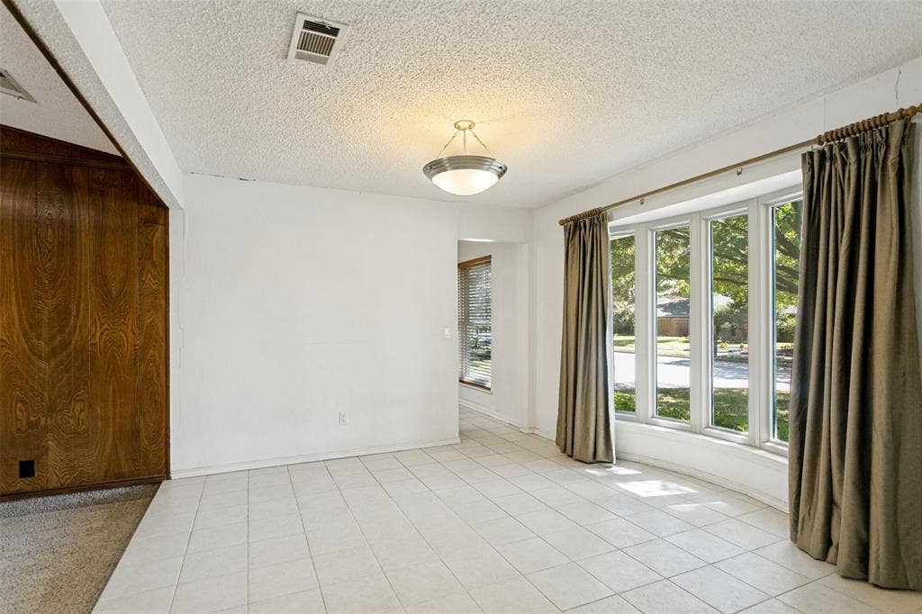 2717 Pinehurst Drive, Plano, TX 75075 White tile flooring, wood-paneled wall, overhead light fixture, and multiple windows