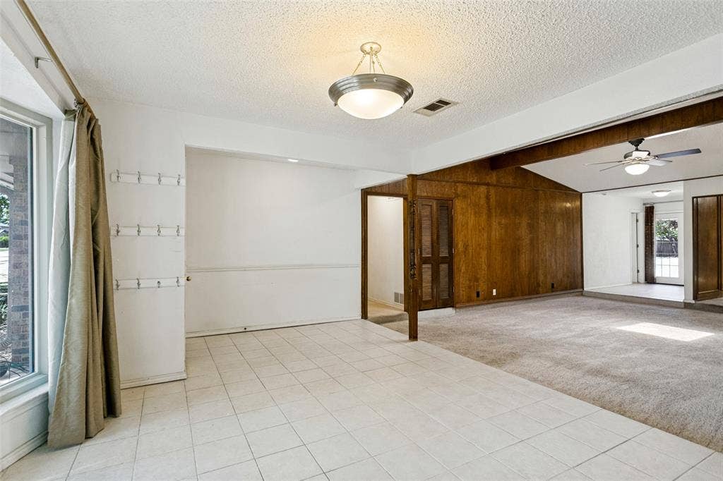 2717 Pinehurst Drive, Plano, TX 75075 Bay window, tiled flooring, wood paneling, vaulted ceiling, and ceiling fan