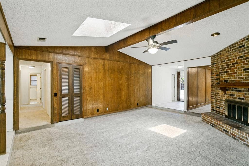 2717 Pinehurst Drive, Plano, TX 75075 Vaulted ceiling with exposed wood beams, skylight, and ceiling fan