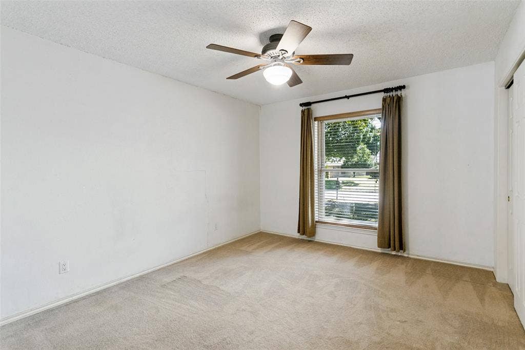 2717 Pinehurst Drive, Plano, TX 75075 Carpeted flooring, window with blinds and drapes, ceiling fan with light fixture, and closet with sliding doors
