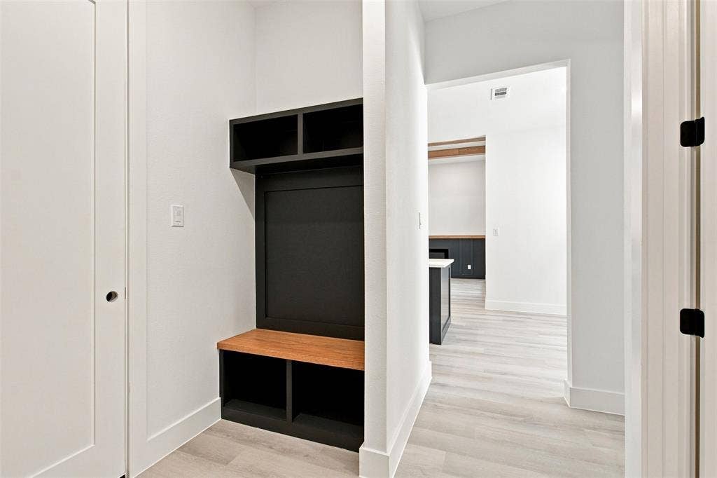 3023 Mallory Drive, Dallas, TX 75216 Built-in storage bench with overhead shelving and wood-finish seating
