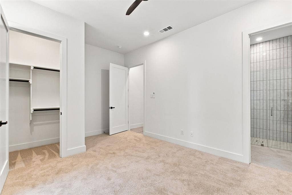 3023 Mallory Drive, Dallas, TX 75216 Recessed lighting, ceiling fan, built-in closet shelving, and a shower with vertical tile