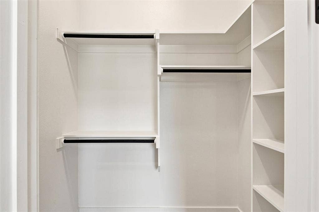 3023 Mallory Drive, Dallas, TX 75216 White-painted closet system featuring multiple hanging rods and integrated shelving