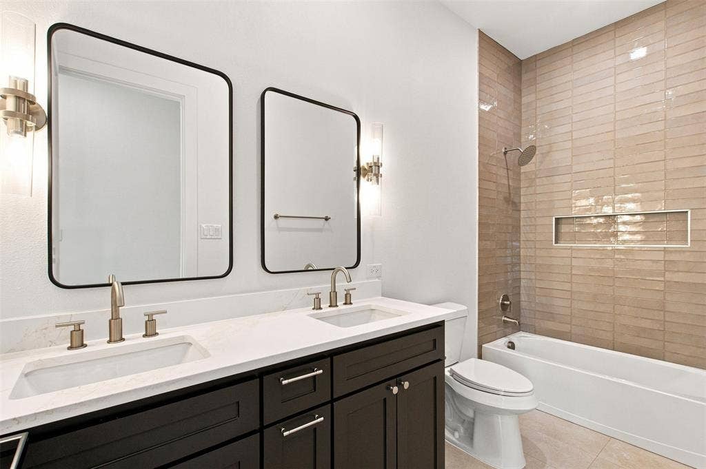 3023 Mallory Drive, Dallas, TX 75216 Dual vanity with undermount sinks, quartz countertop, and brushed nickel fixtures