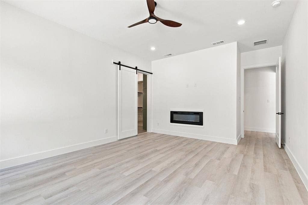 3023 Mallory Drive, Dallas, TX 75216 Recessed lighting, wood-finish flooring, ceiling fan, built-in fireplace, and barn door